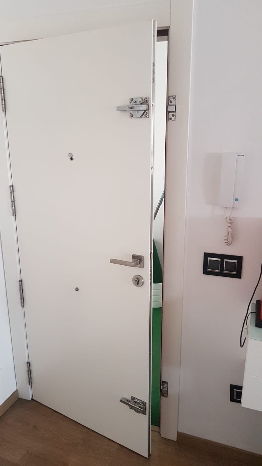Puerta de seguridad blanca con manilla y cerradura nuevas